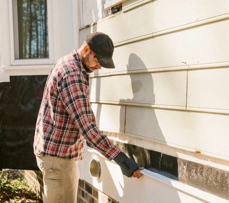Worker repairing exterior wall